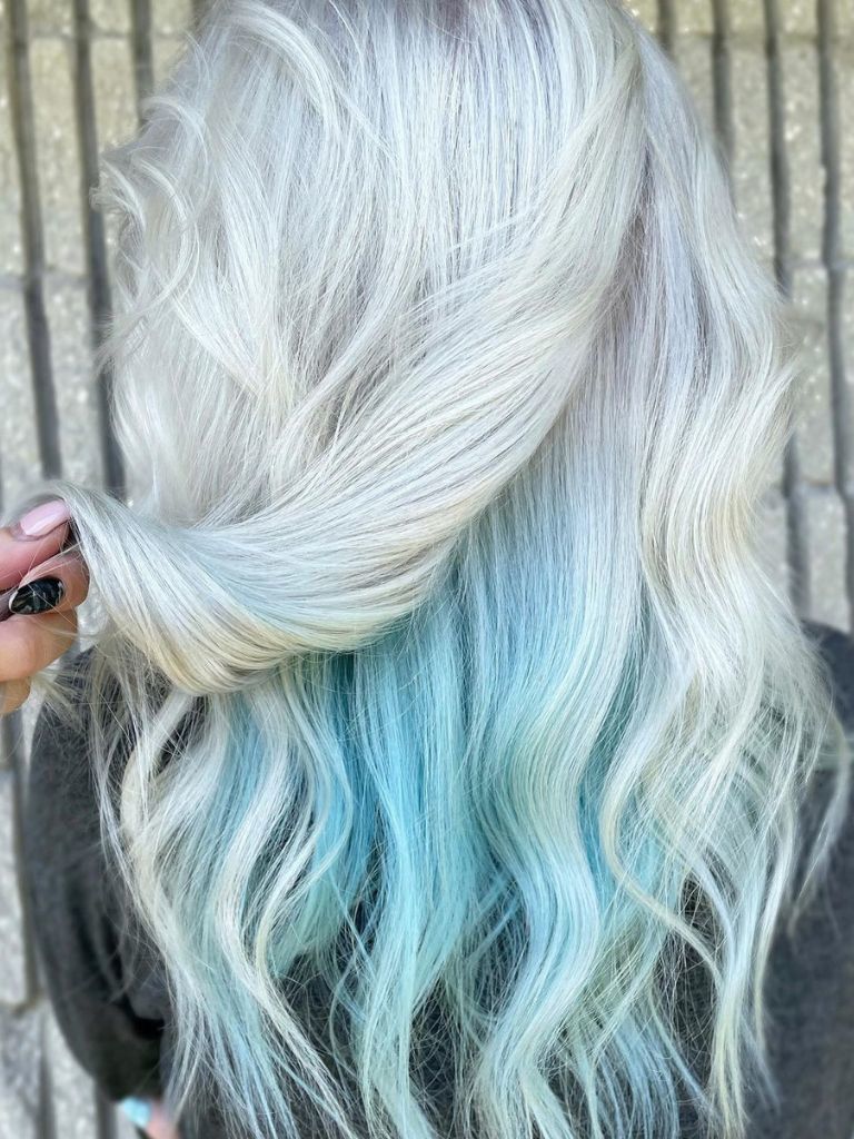 Person with silver hair with blue dye underneath.