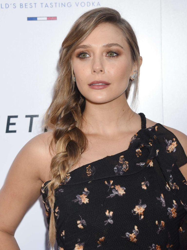 Elizabeth Olsen with a light brown loose long braid.