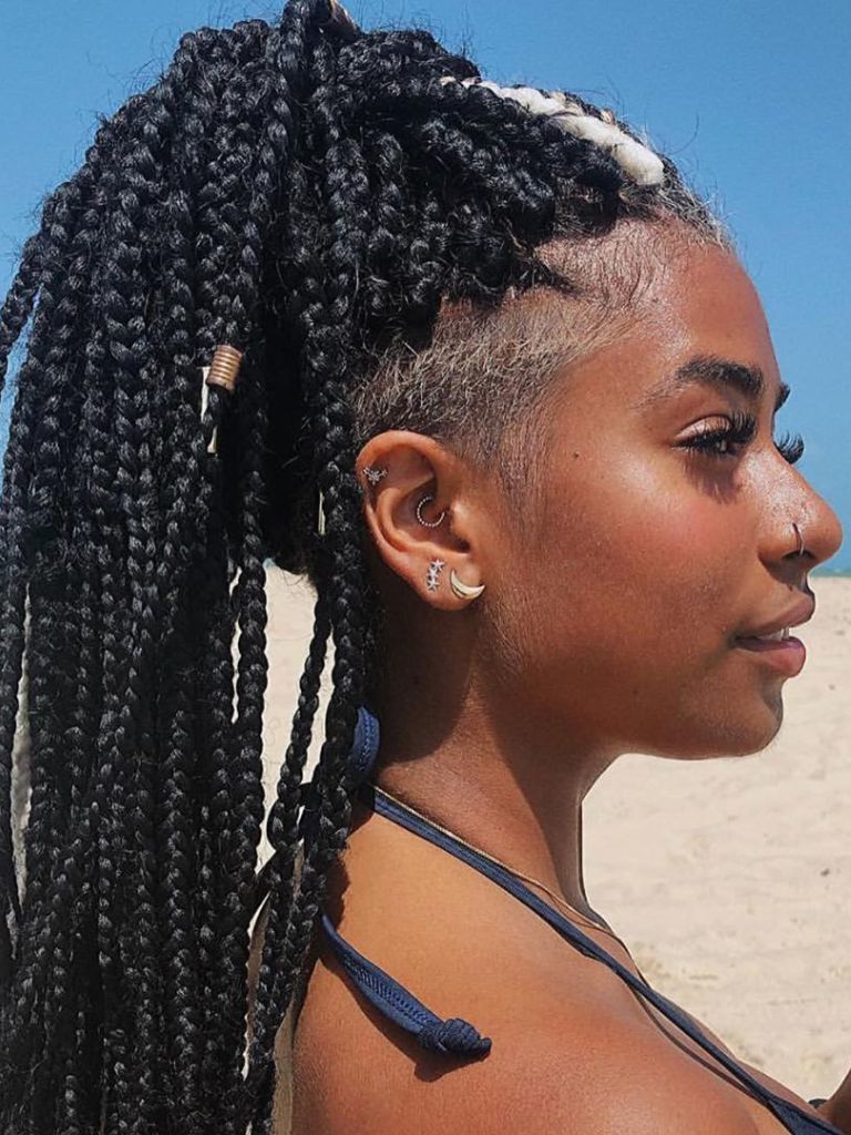 Woman with box braids ponytail with shaved blonde undercut and accessories.