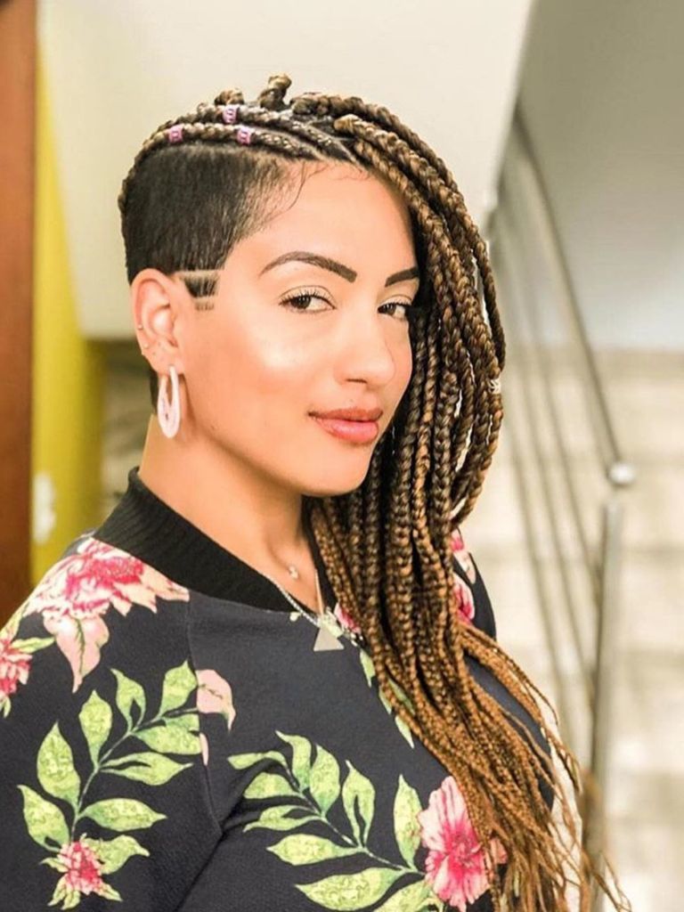 Woman with blonde long box braids with shaved buzz cut.