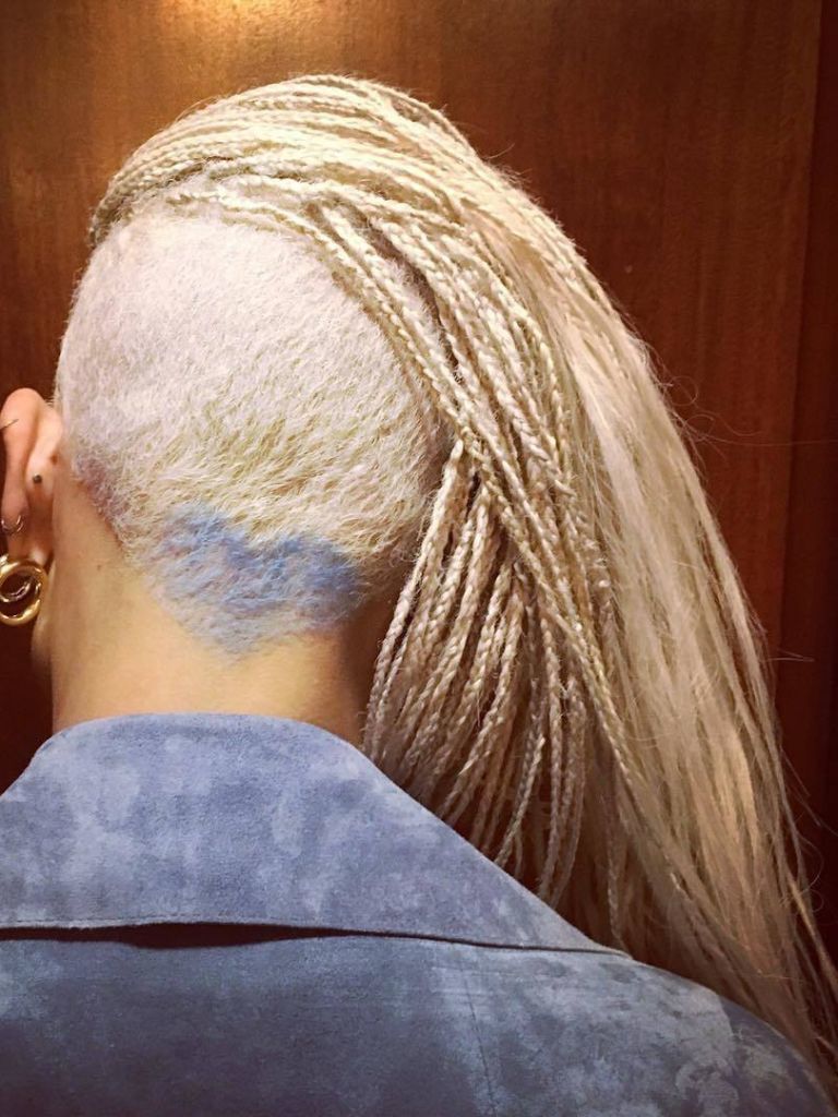 Zoe Kravitz with micro blonde box braids and buzzed undercut hairstyle with heart design.