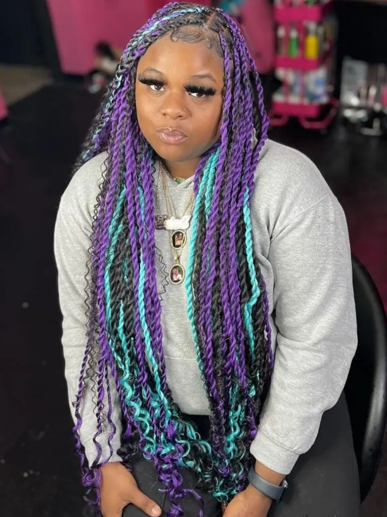 Woman with long purple, blue and black Marley twists