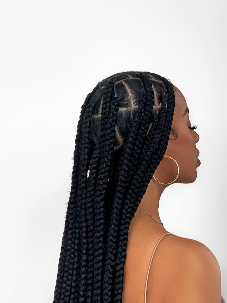 Woman with jumbo knotless braids.