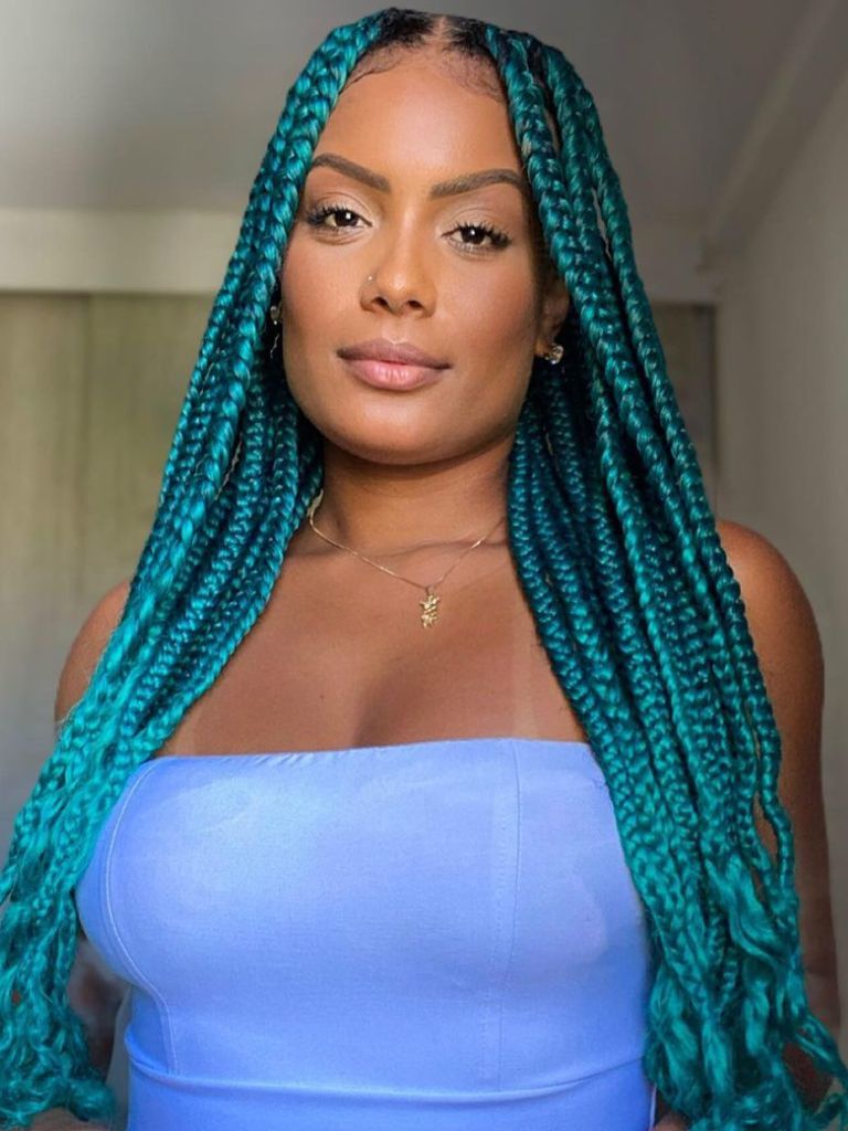 Woman with blue knotless mermaid braids.