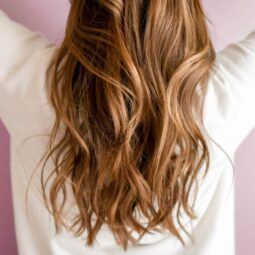Woman with caramel balayage hair with pretty waves.