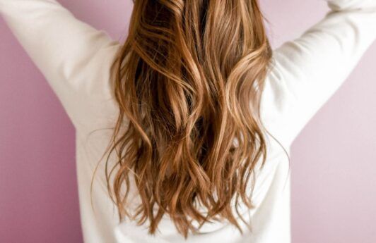 Woman with caramel balayage hair with pretty waves.
