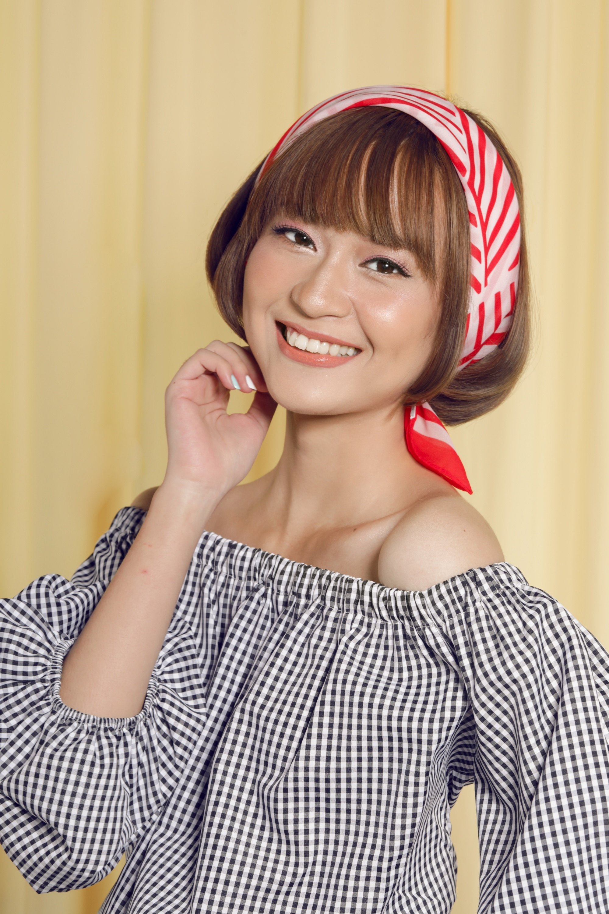 Asian woman with short hair with bangs wearing a headband