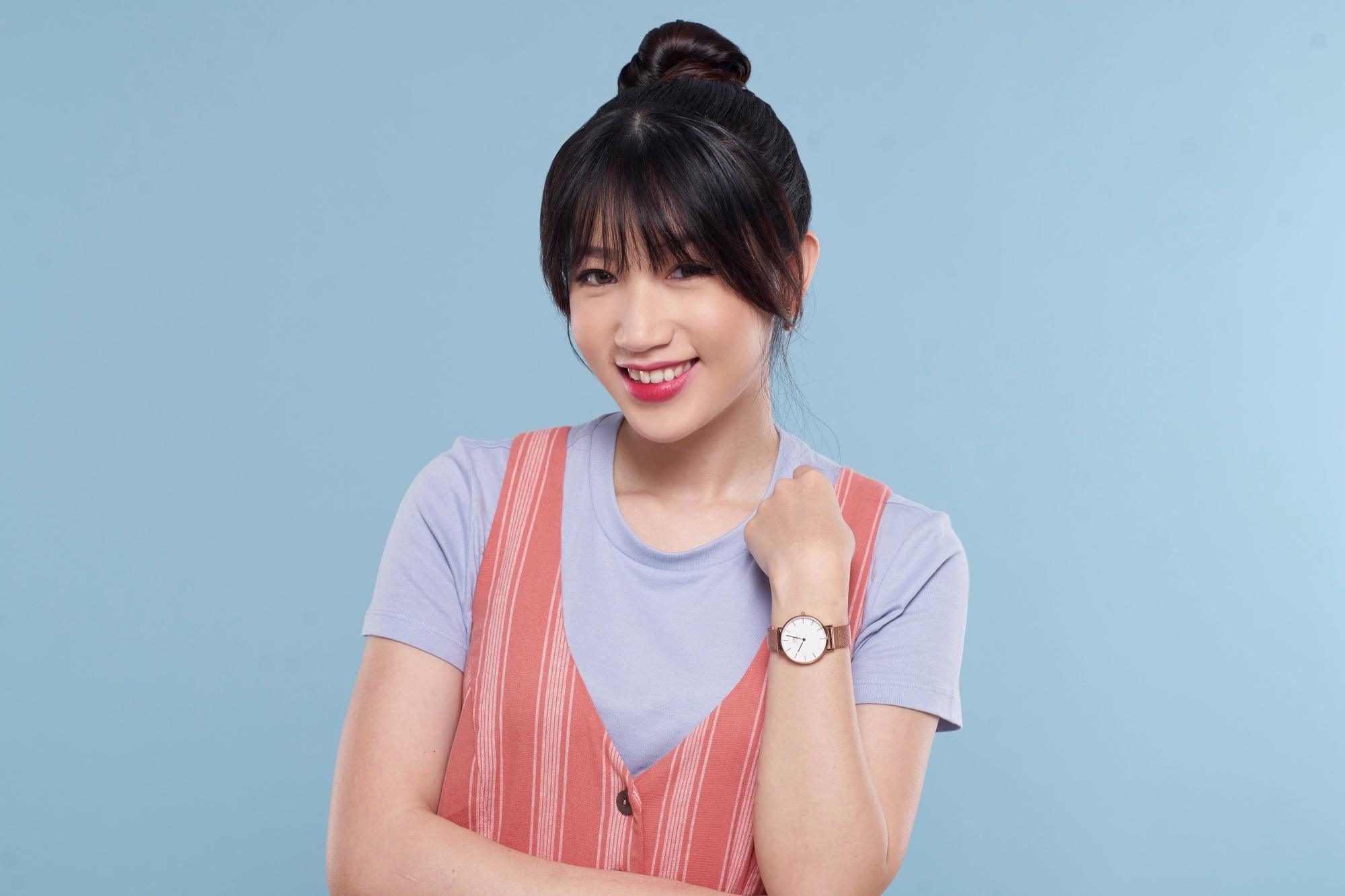 Asian woman with a top knot hairstyle with bangs