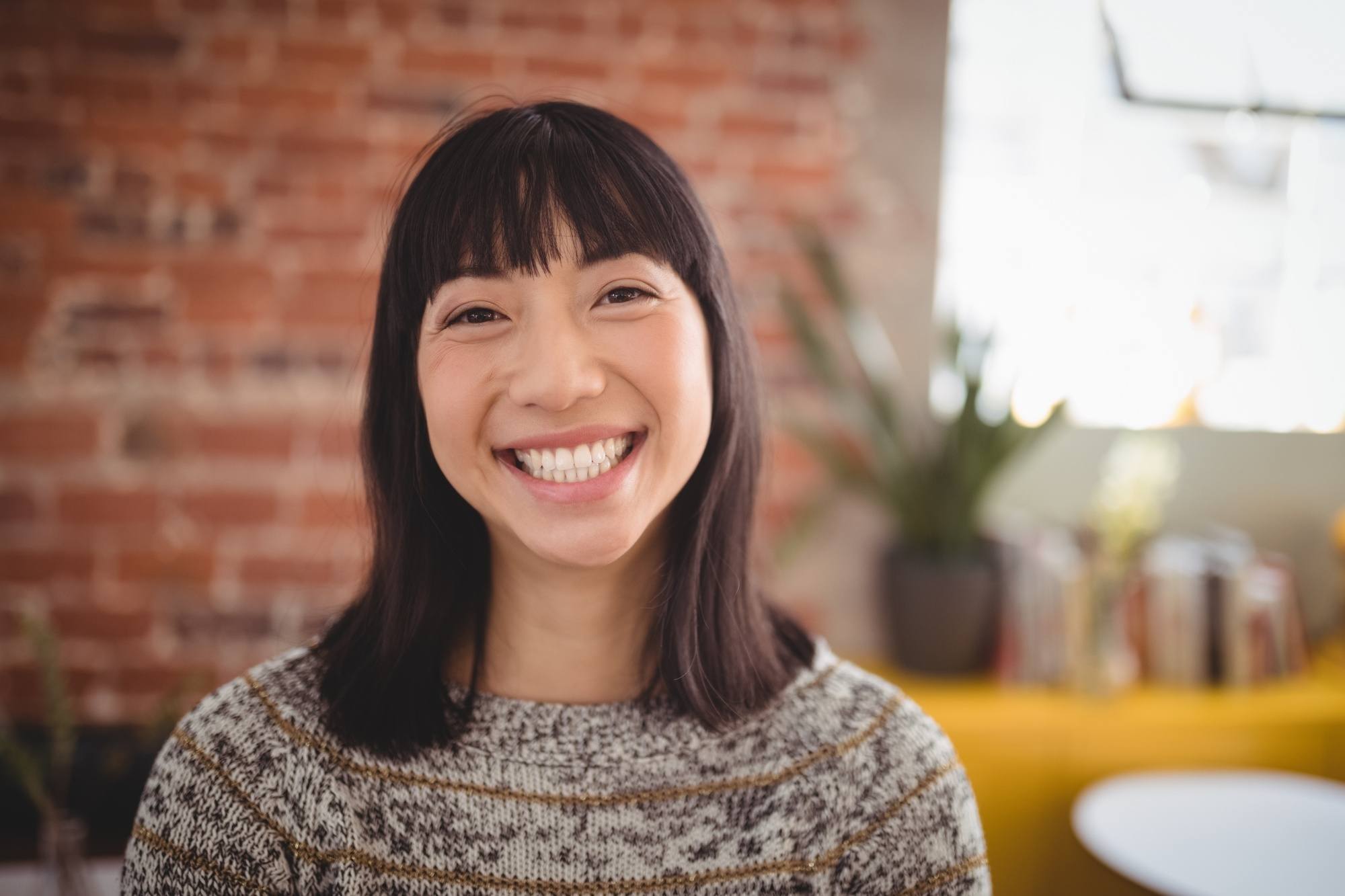 Asian woman with shoulder-length hair with bangs