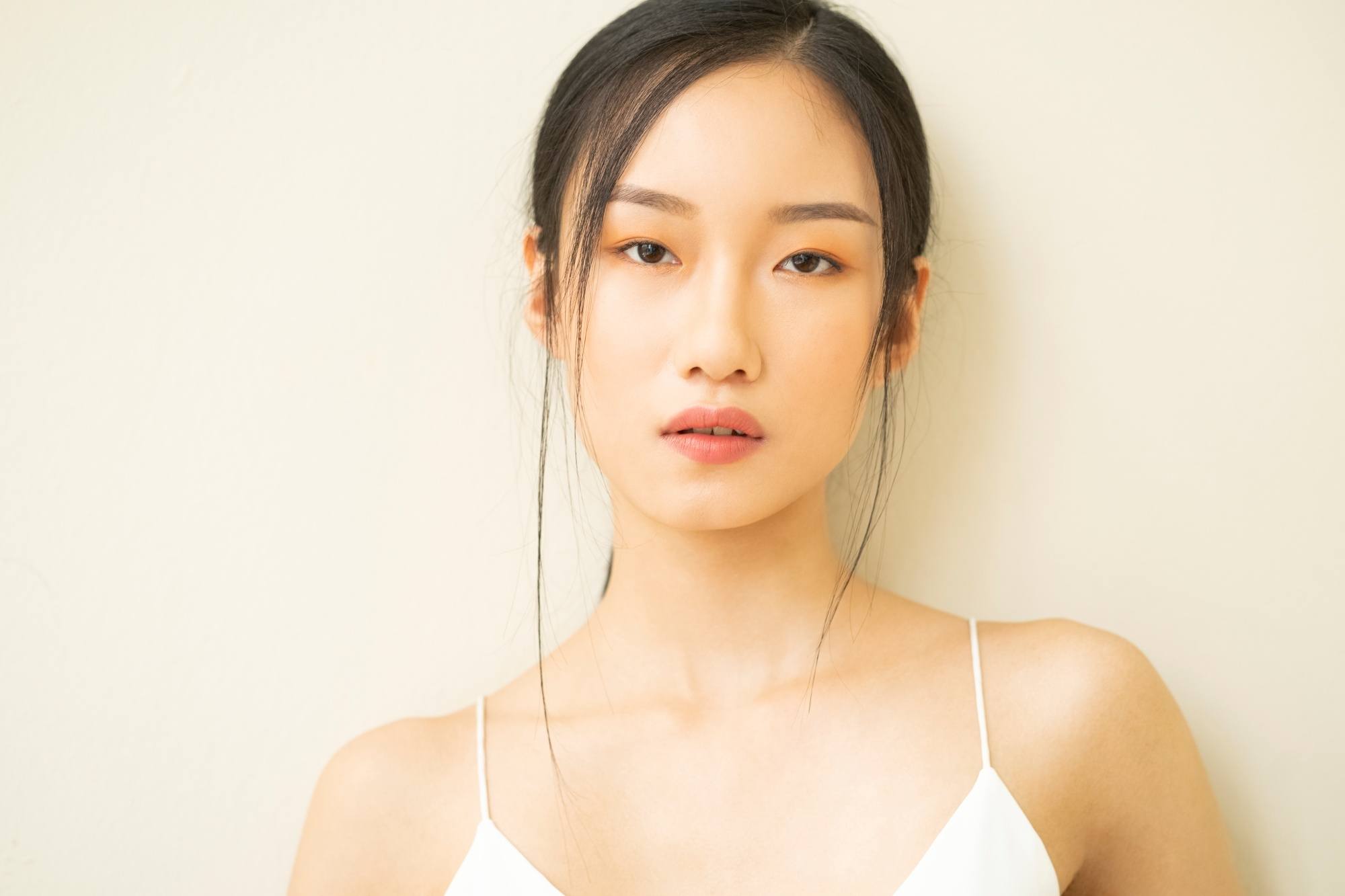 Asian woman with tendrils framing her face