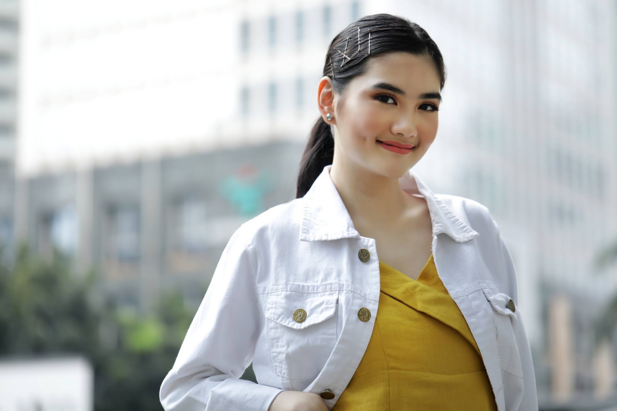 Asian woman with a ponytail and bobby pins on her hair