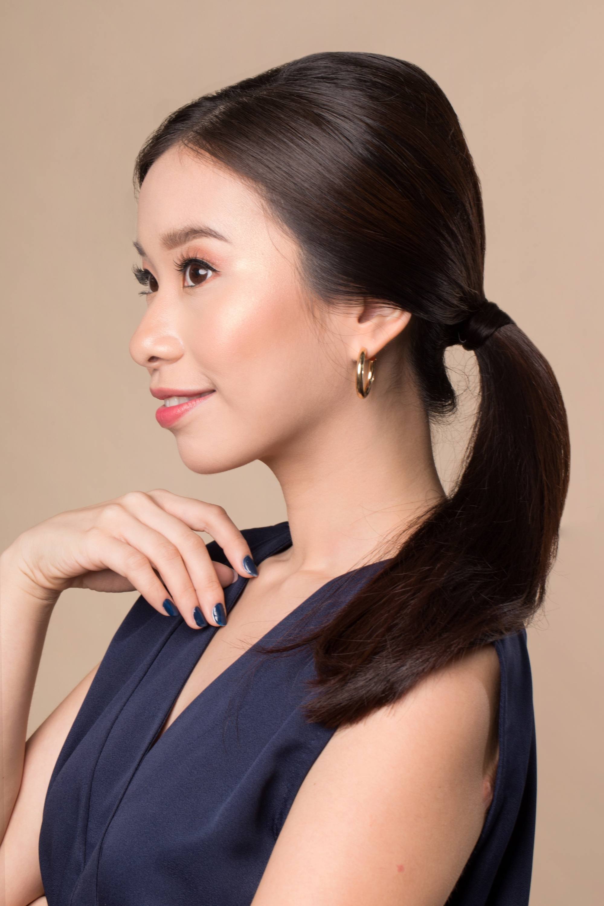 Side view of an Asian woman with a vintage ponytail hairstyle