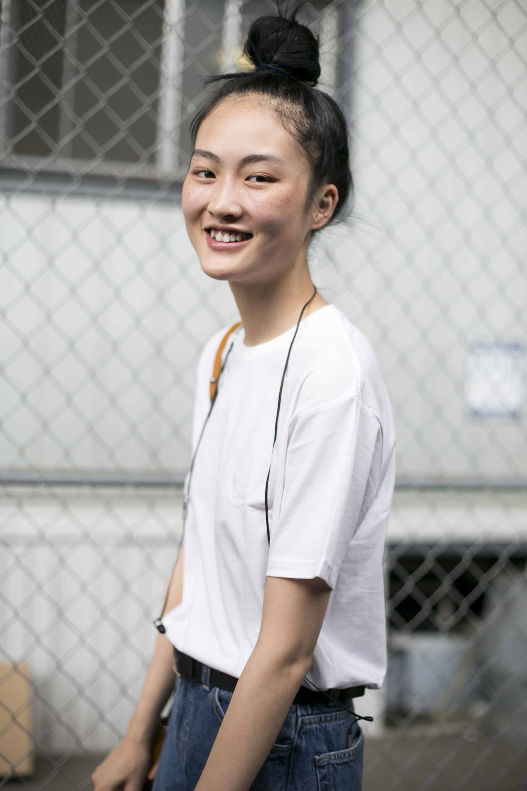 asian girl with a top knot bun hairstyle