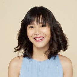 Short hairstyles for fine hair: Asian woman with short hair in beach waves hairstyles wearing a light blue dress