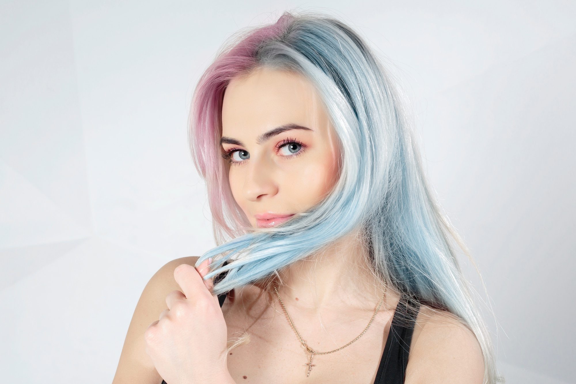 How often should you change your hair color: Woman with pink and blue long hair wearing a black sleeveless top