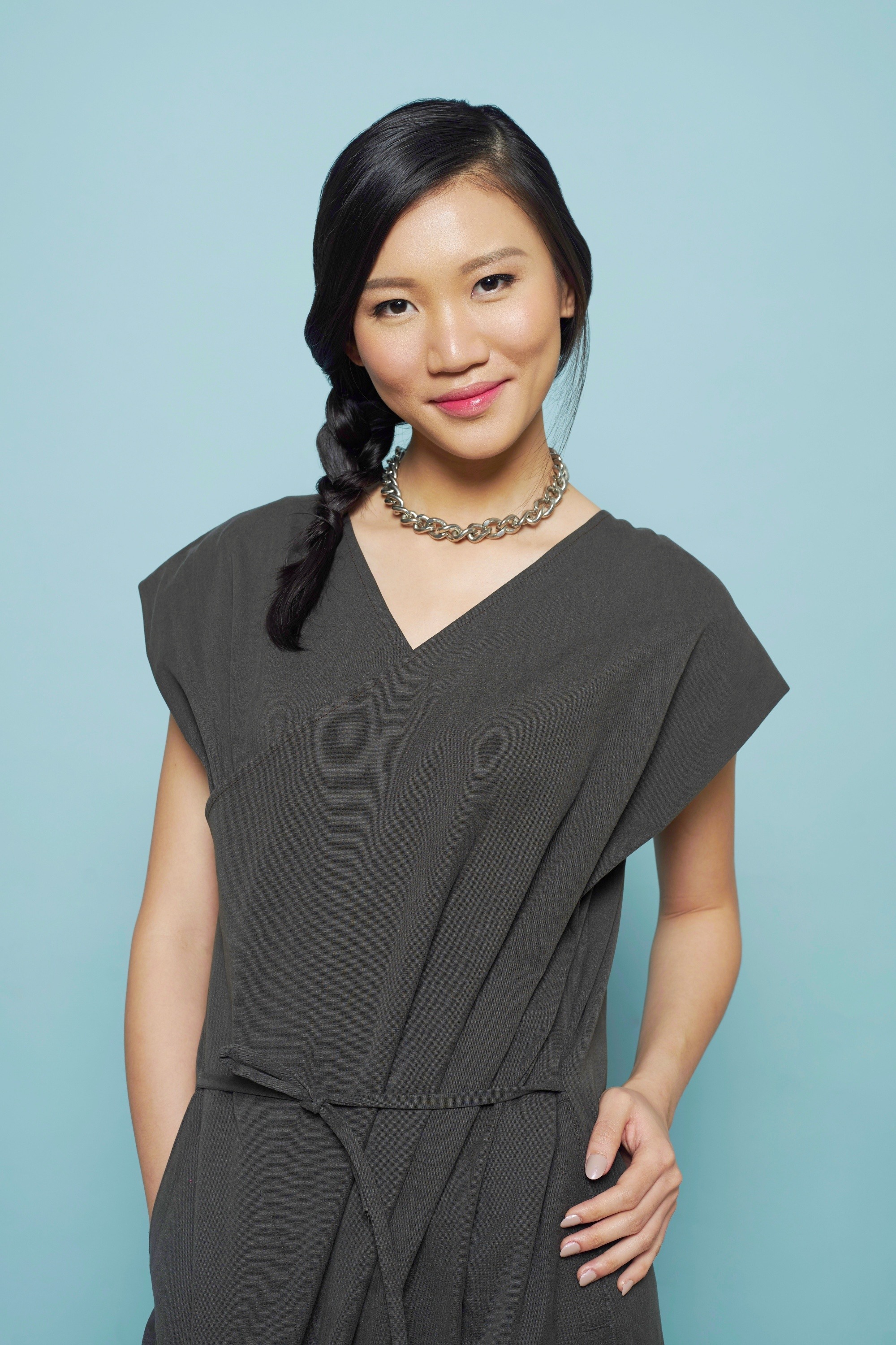 Asian woman with a side braid smiling