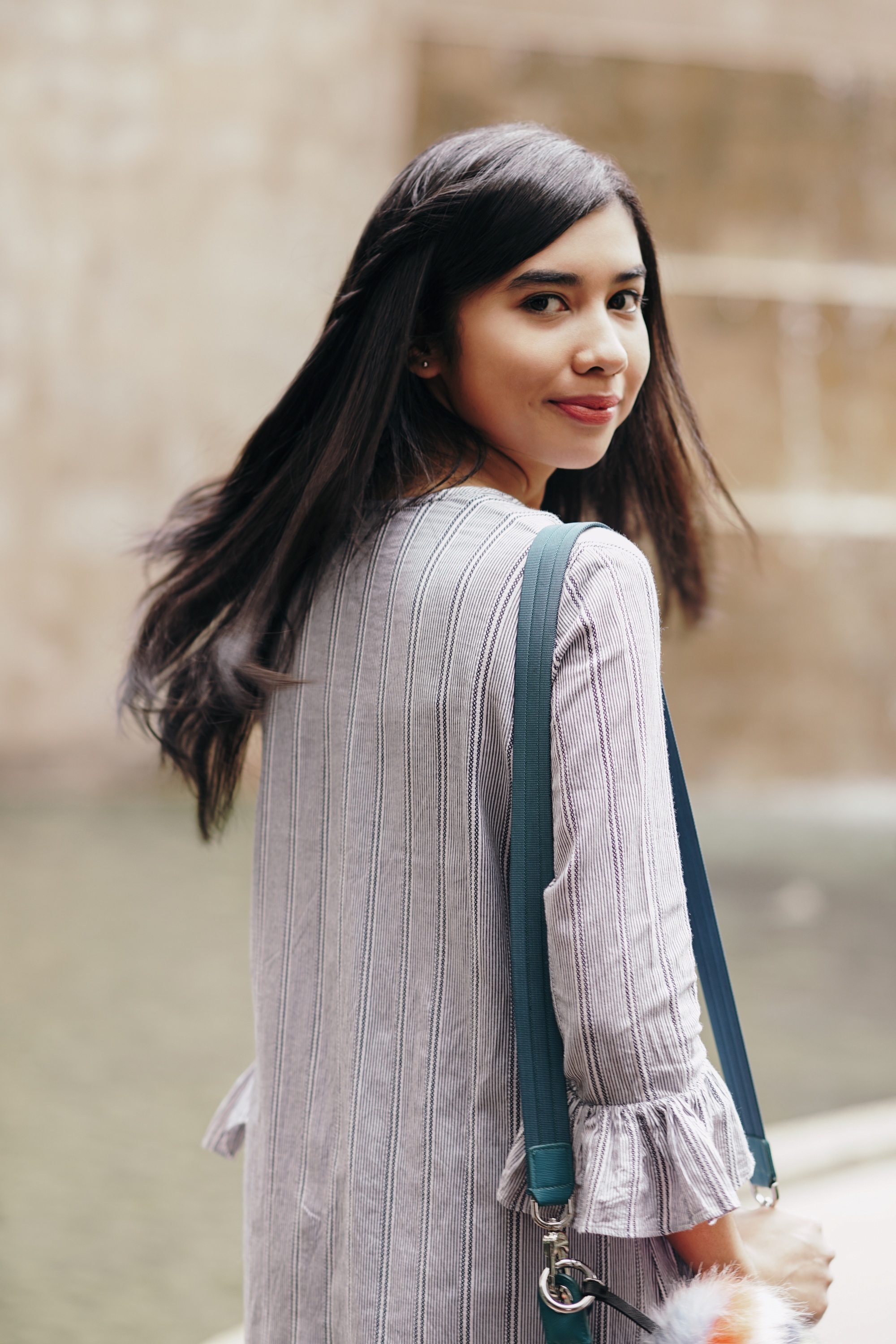 Keratin conditioners: Asian woman with long black layered hair wearing a cardigan