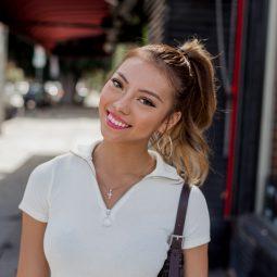 Asian woman with hair styled into a high ponytail