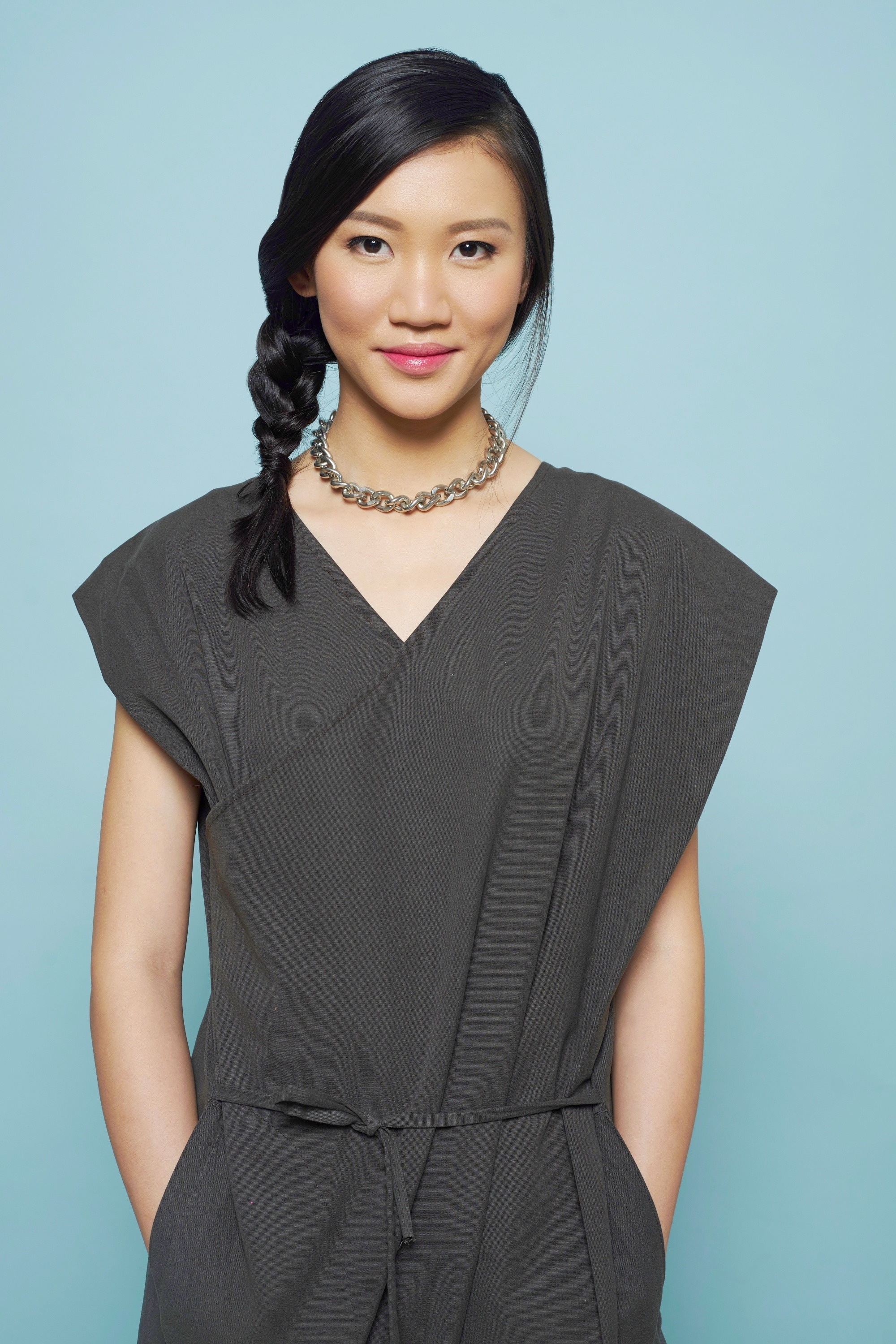 Asian woman with a side braid wearing a romper