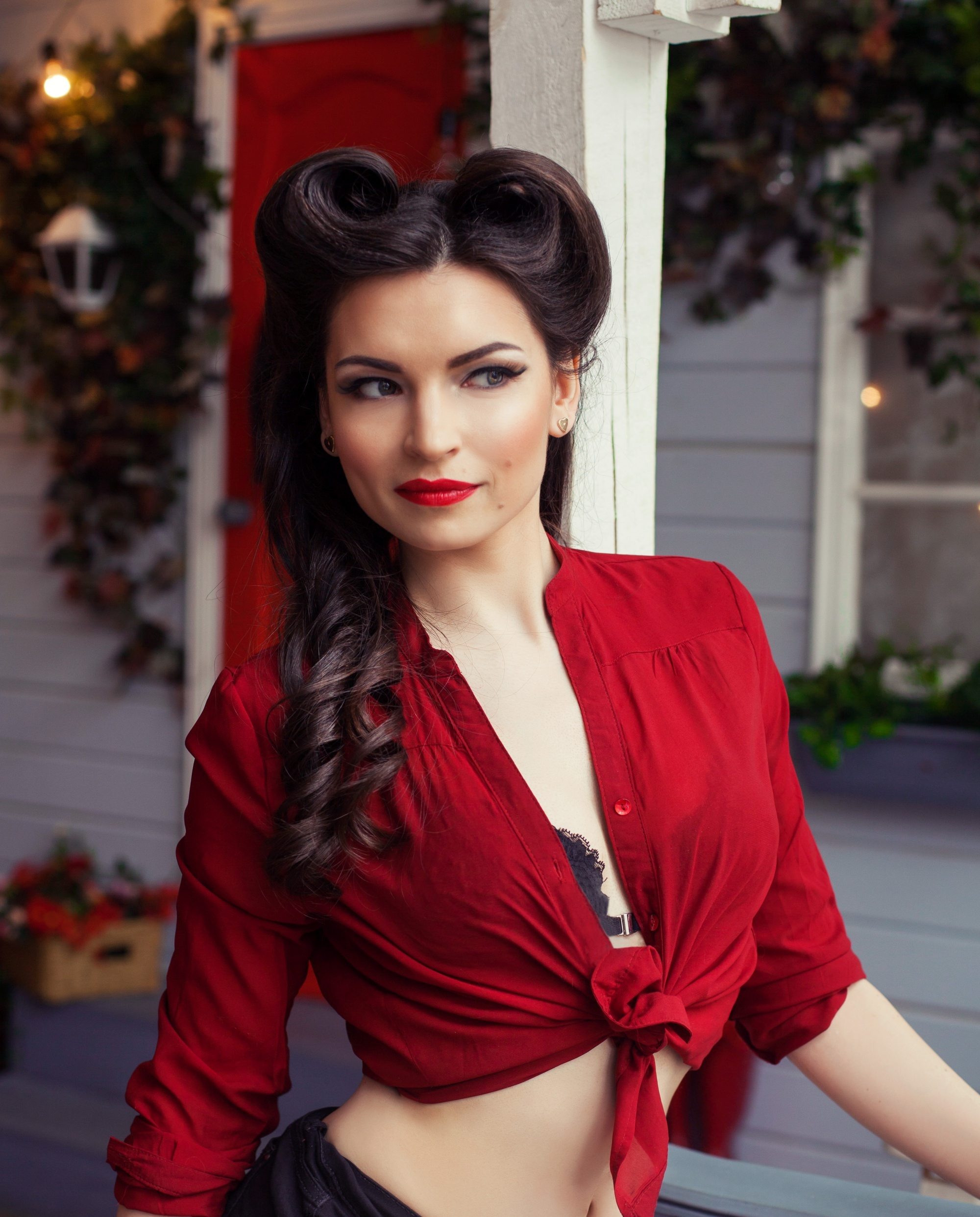 Rockabilly hair: Woman with long hair in a twisted long rockabilly hairdo wearing a red cropped top