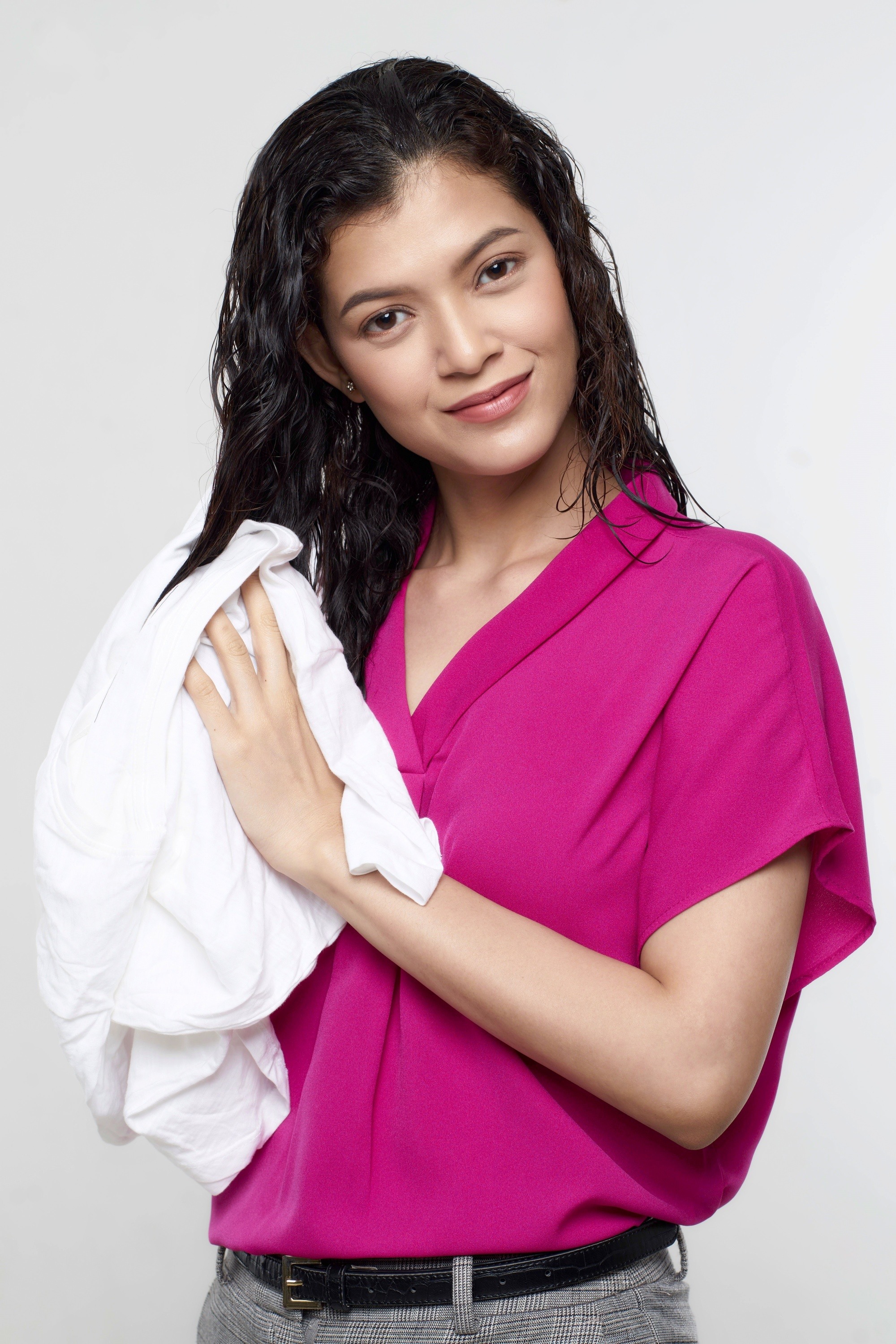 Asian woman drying her hair with a smooth towel