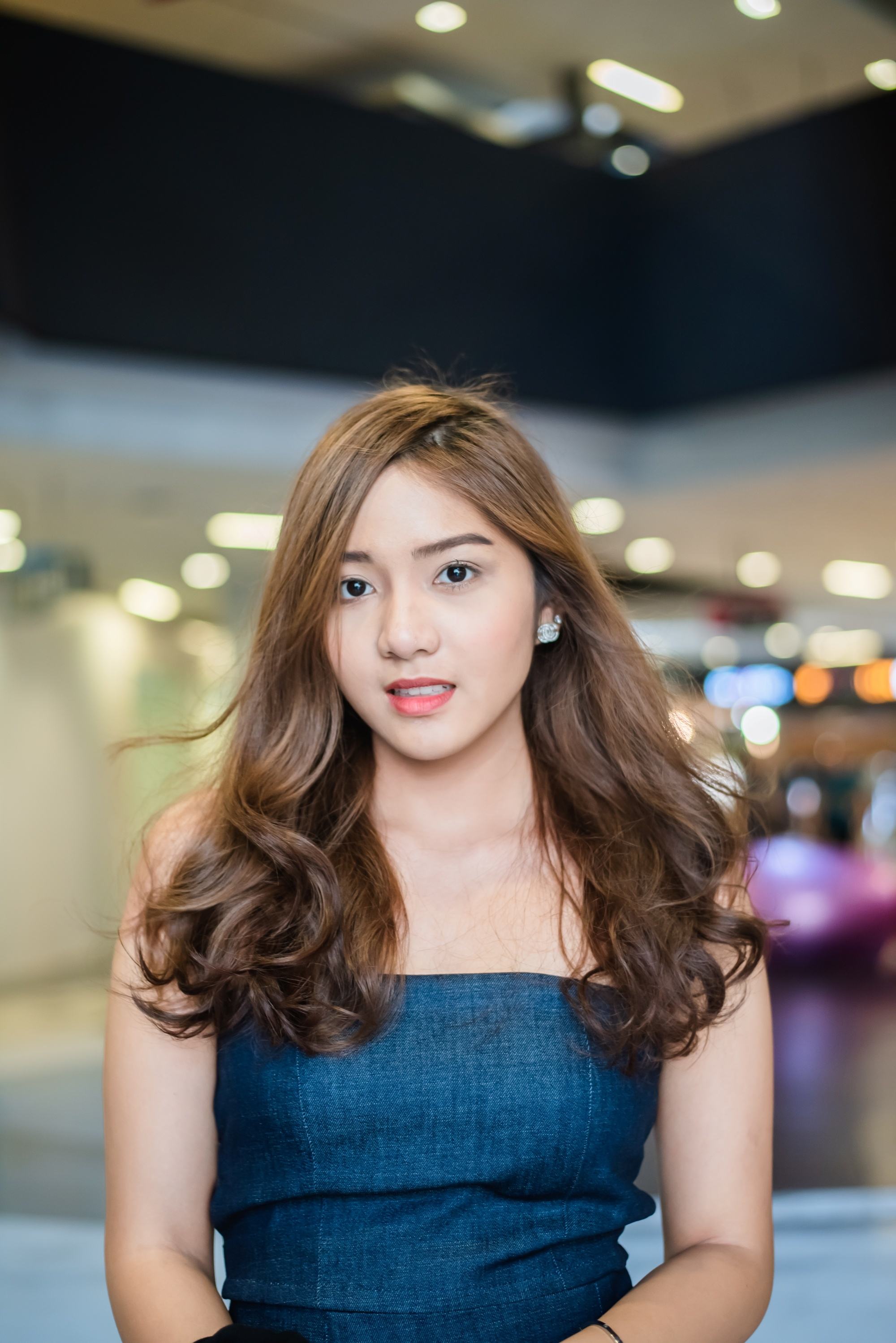 Asian woman with chocolate brown hair color wearing a teal dress