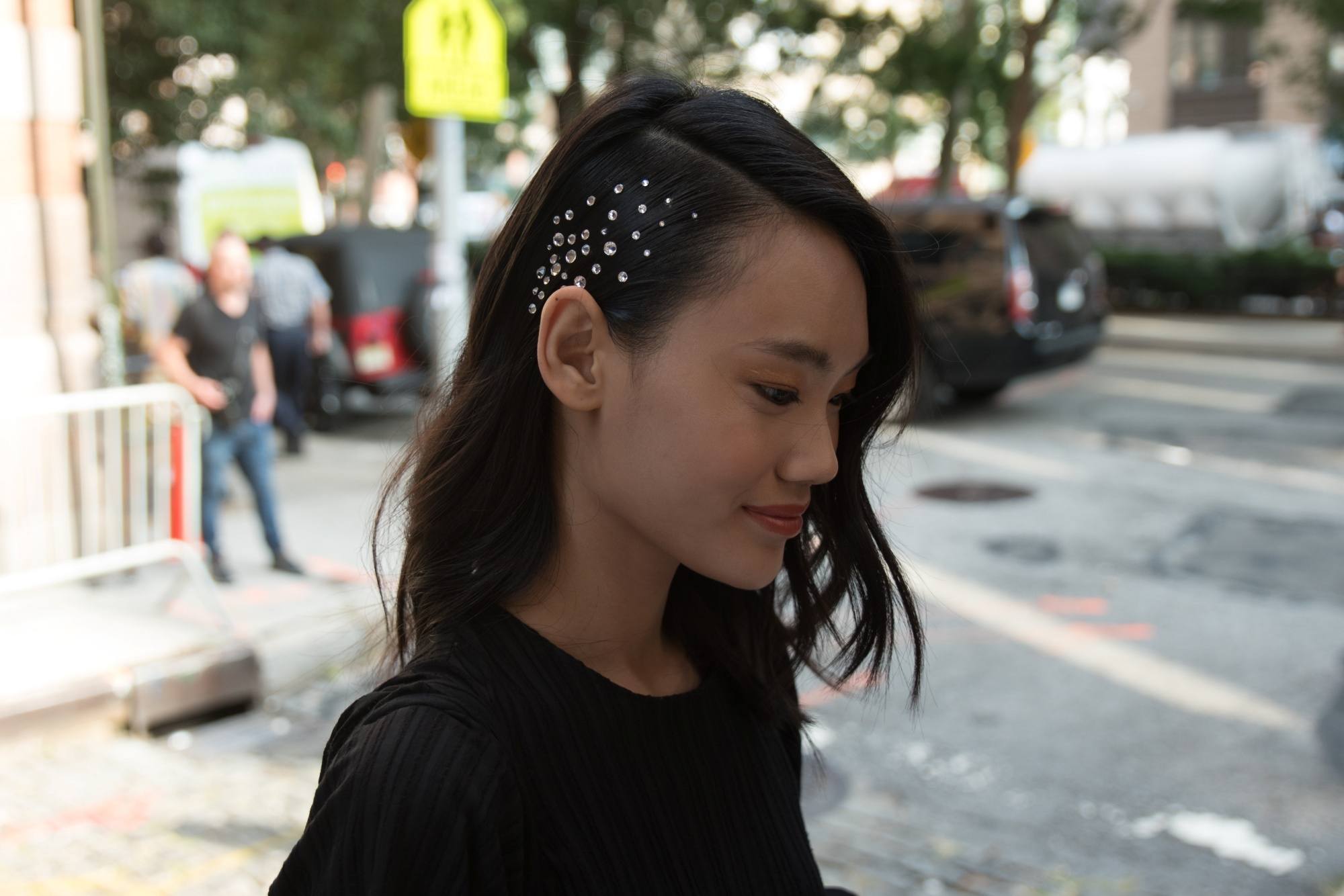 Asian woman with a tousled hairstyle adorned with hair studs