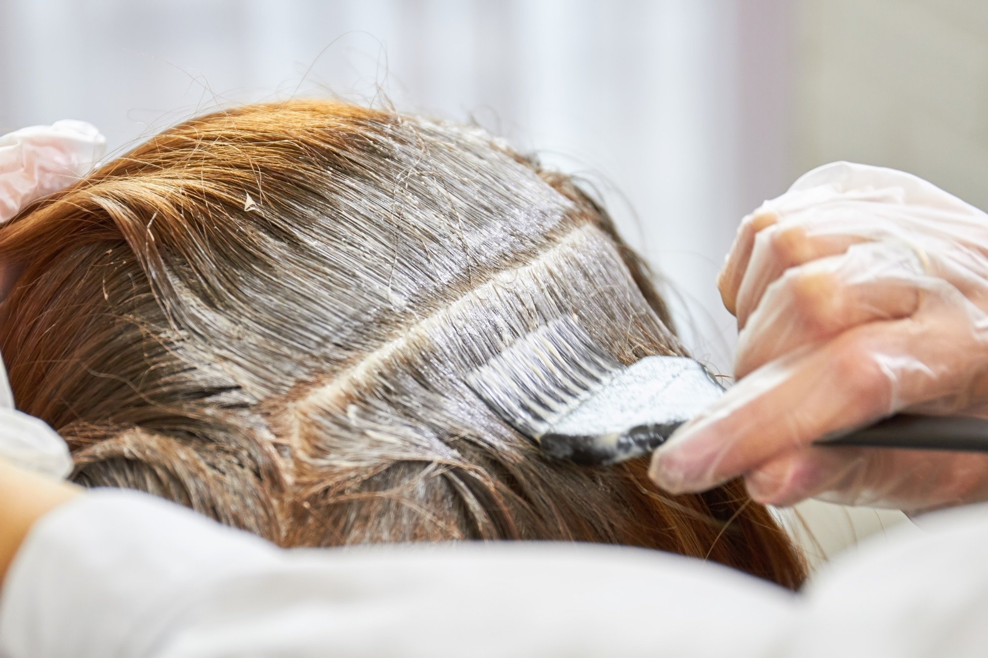 View of hair that is being applied with a hair product