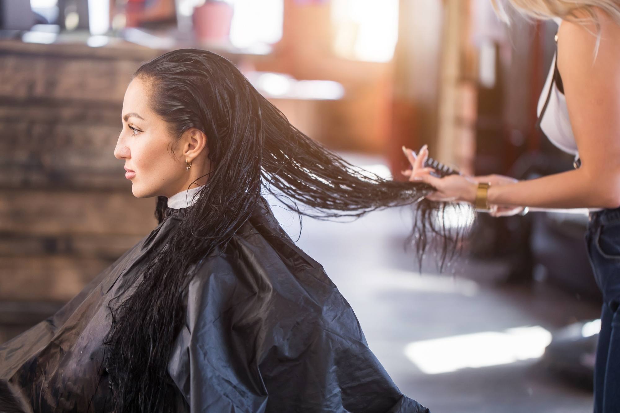 Keratin Smoothing Treatment: Woman with long hair at a salon