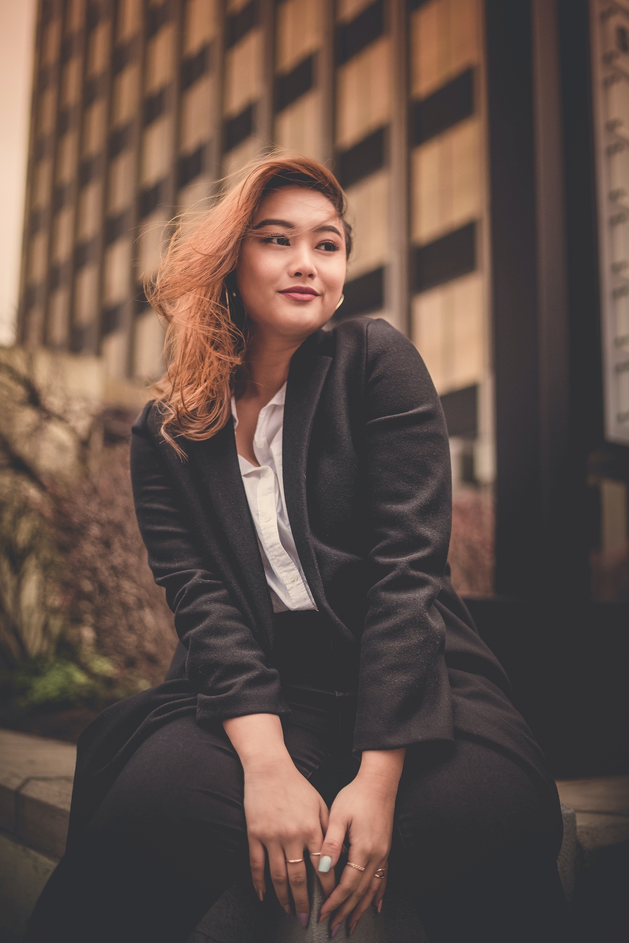 Woman with deep reddish hair wearing a black jacket