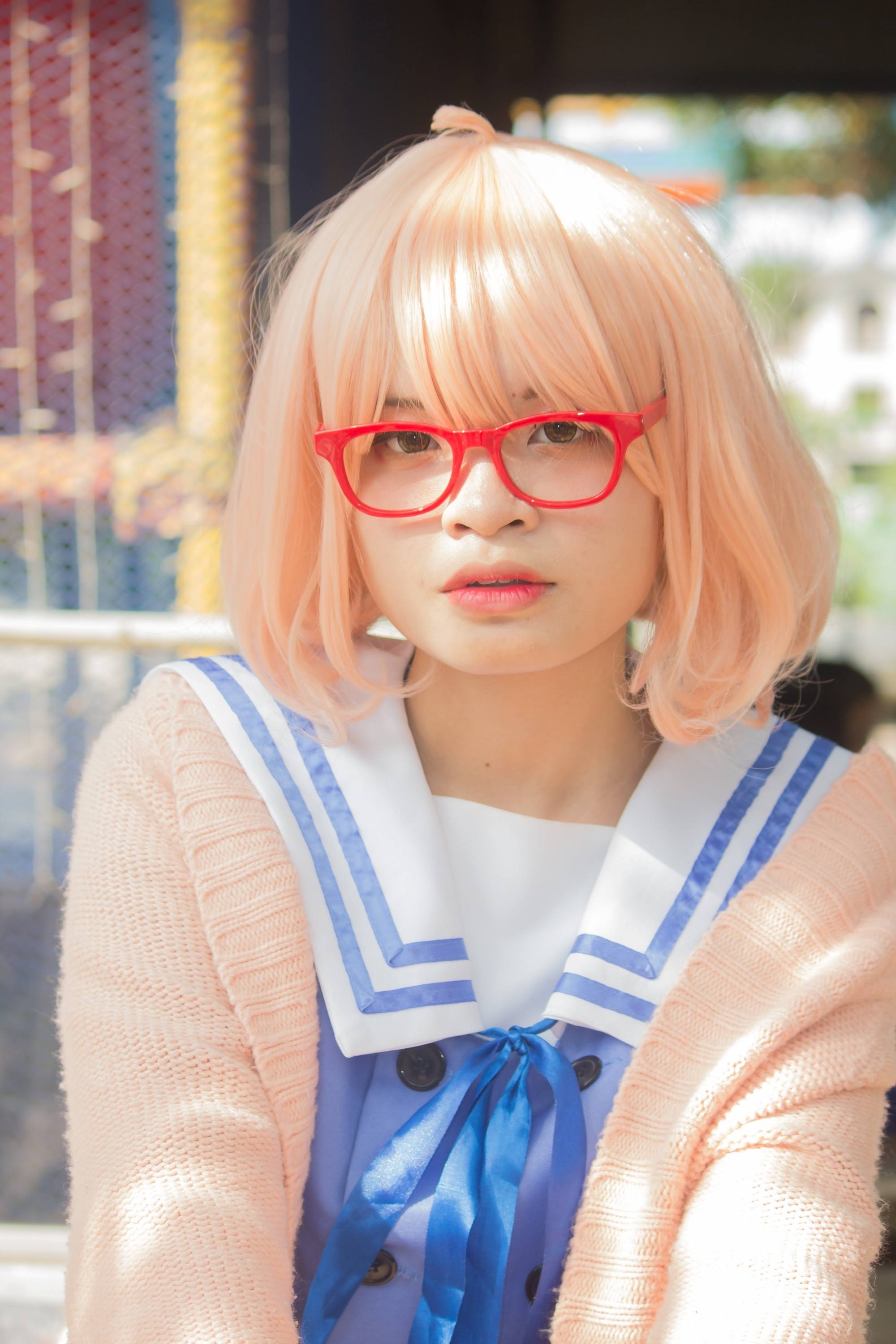 Asian woman with short strawberry blonde hair
