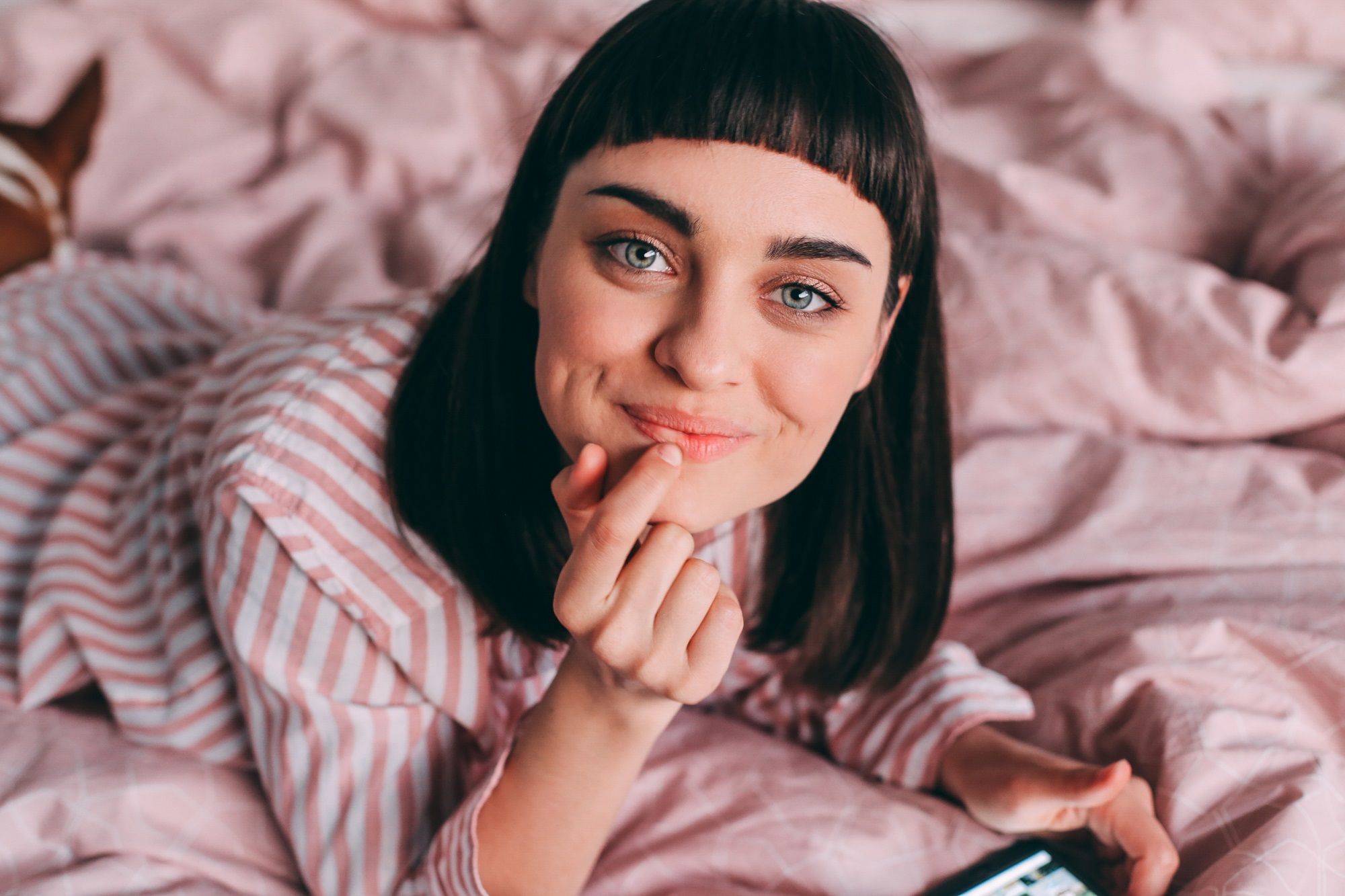 Hairstyles for baby bangs: Closeup shot of woman with straight black lob with baby bangs