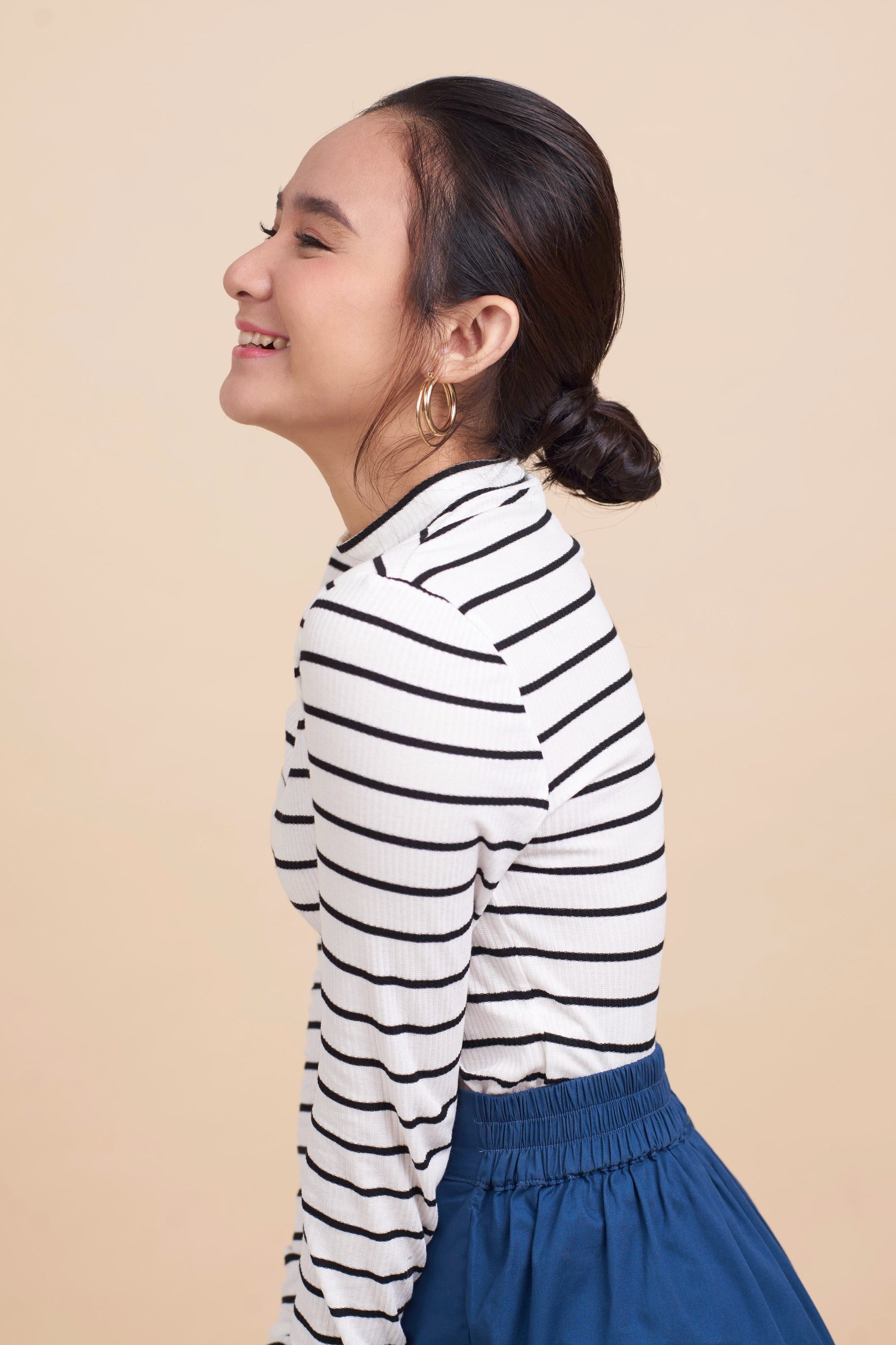 Side view of an Asian woman with a baby bun for short hair