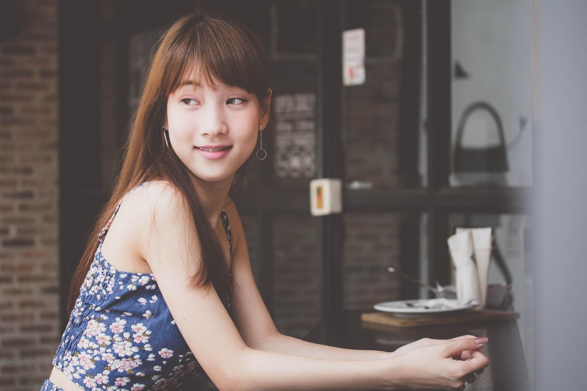 Straight bangs: Asian woman with long bangs side-swept