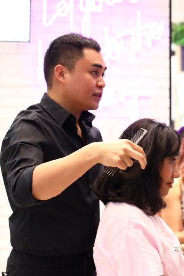 Hairstylist Jay Wee giving a free hair makeover