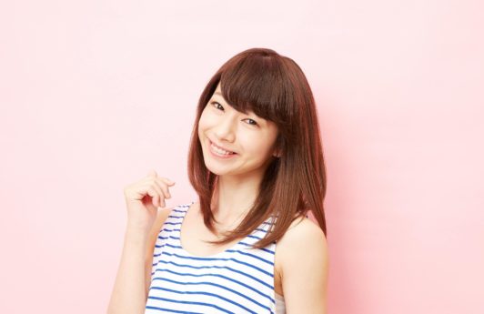 Asian woman with brown hair against pink background to represent users of new Sunsilk Smooth and Manageable Shampoo