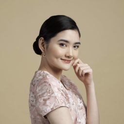 Asian woman with sleek low bun with side part
