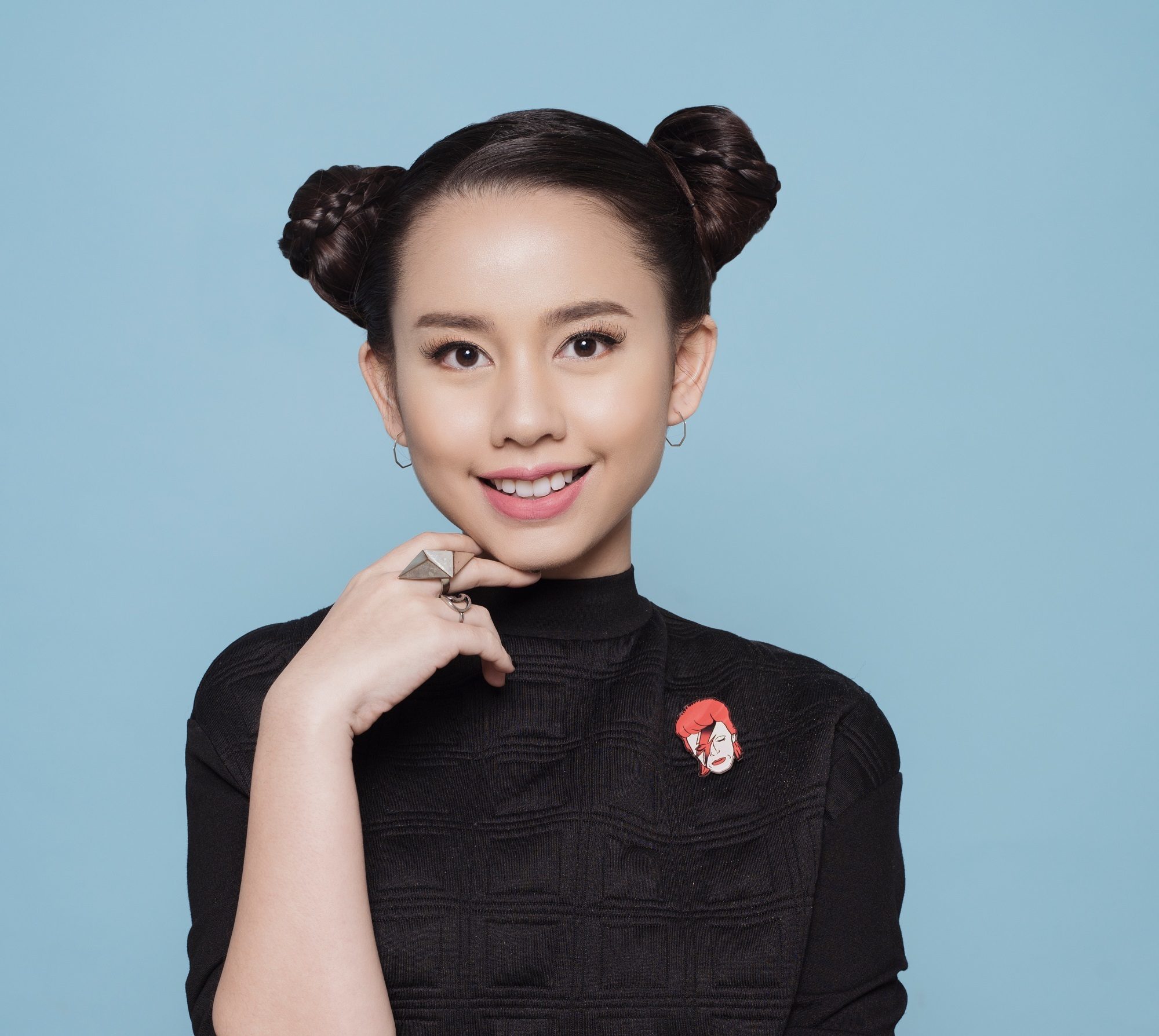 Advent calendar: Closeup shot of Asian girl with black hair in space buns wearing a black shirt