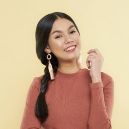 Messy side braid: Asian woman wearing a brown long-sleeved shirt with long black hair in braids