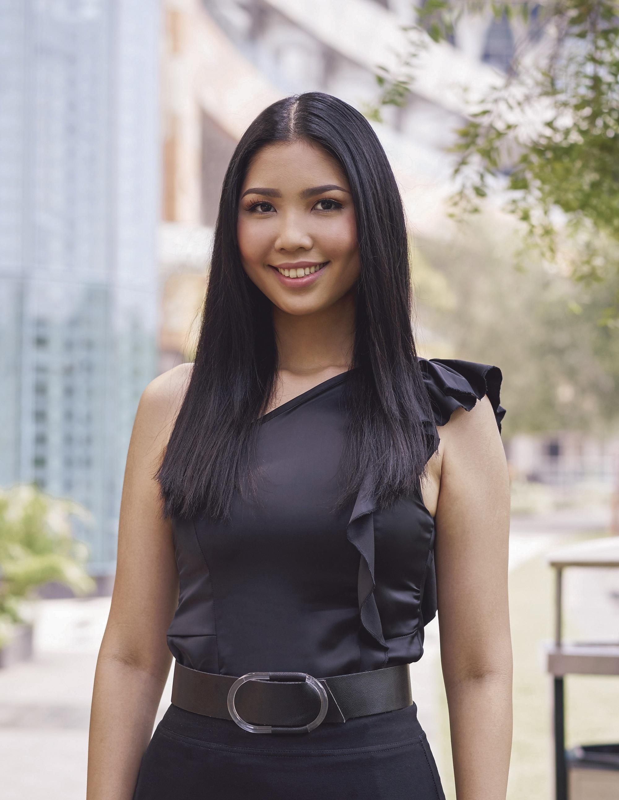 Cream Silk Triple Keratin Rescue Ultimate Straight Glamorously Straight Hair: Asian woman with long black straight hair and wearing black top and skirt in a city park