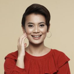 How to style wet to dry pixie: Closeup shot of an Asian woman with styled pixie cut wearing a red blouse