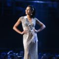 Miss Universe 2018 hairstyles : Miss Puerto Rico Kiara Ortega with long black hair in high ponytail and silver evening gown on stage