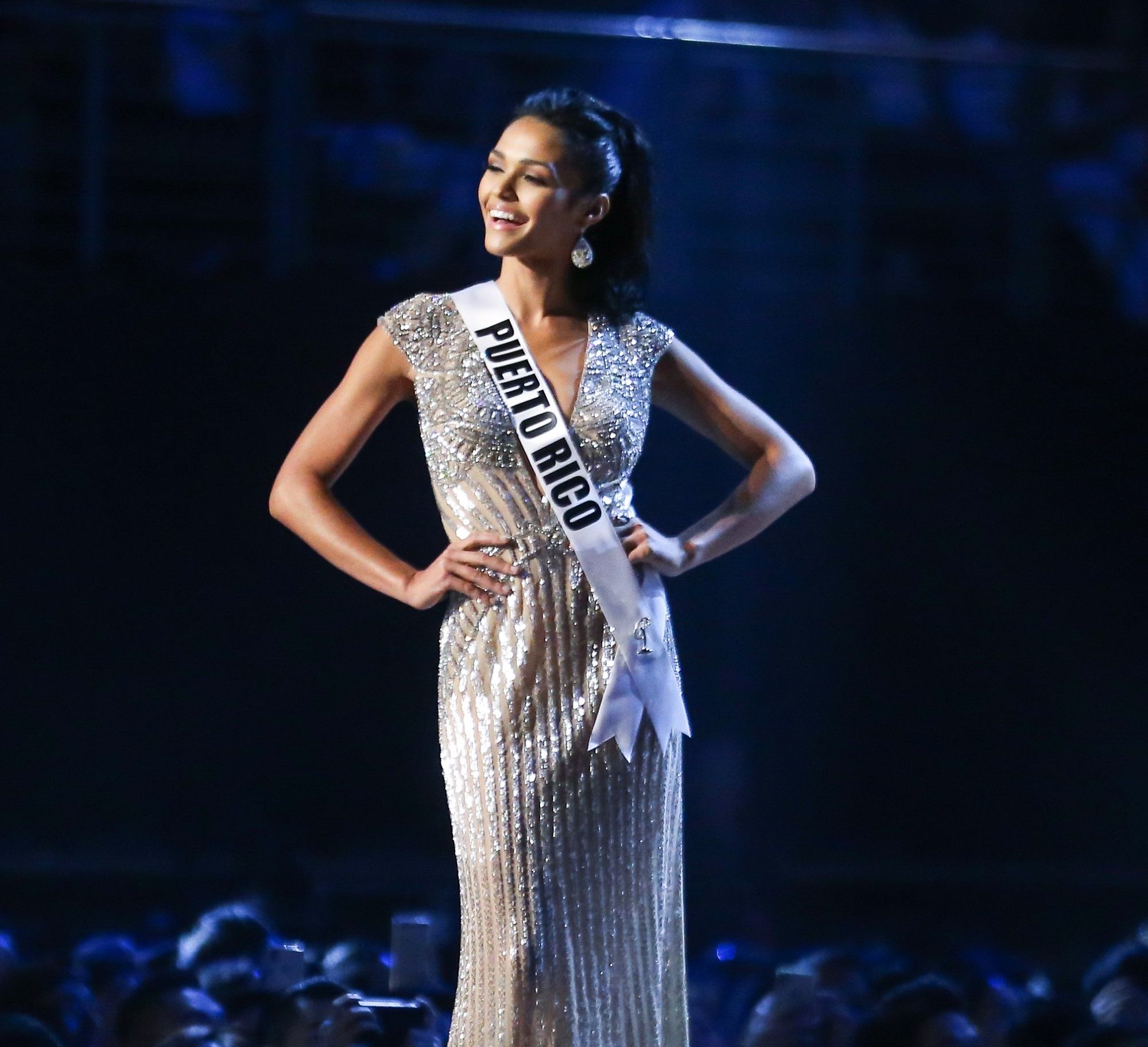 Miss Universe 2018 hairstyles : Miss Puerto Rico Kiara Ortega with long black hair in high ponytail and silver evening gown on stage