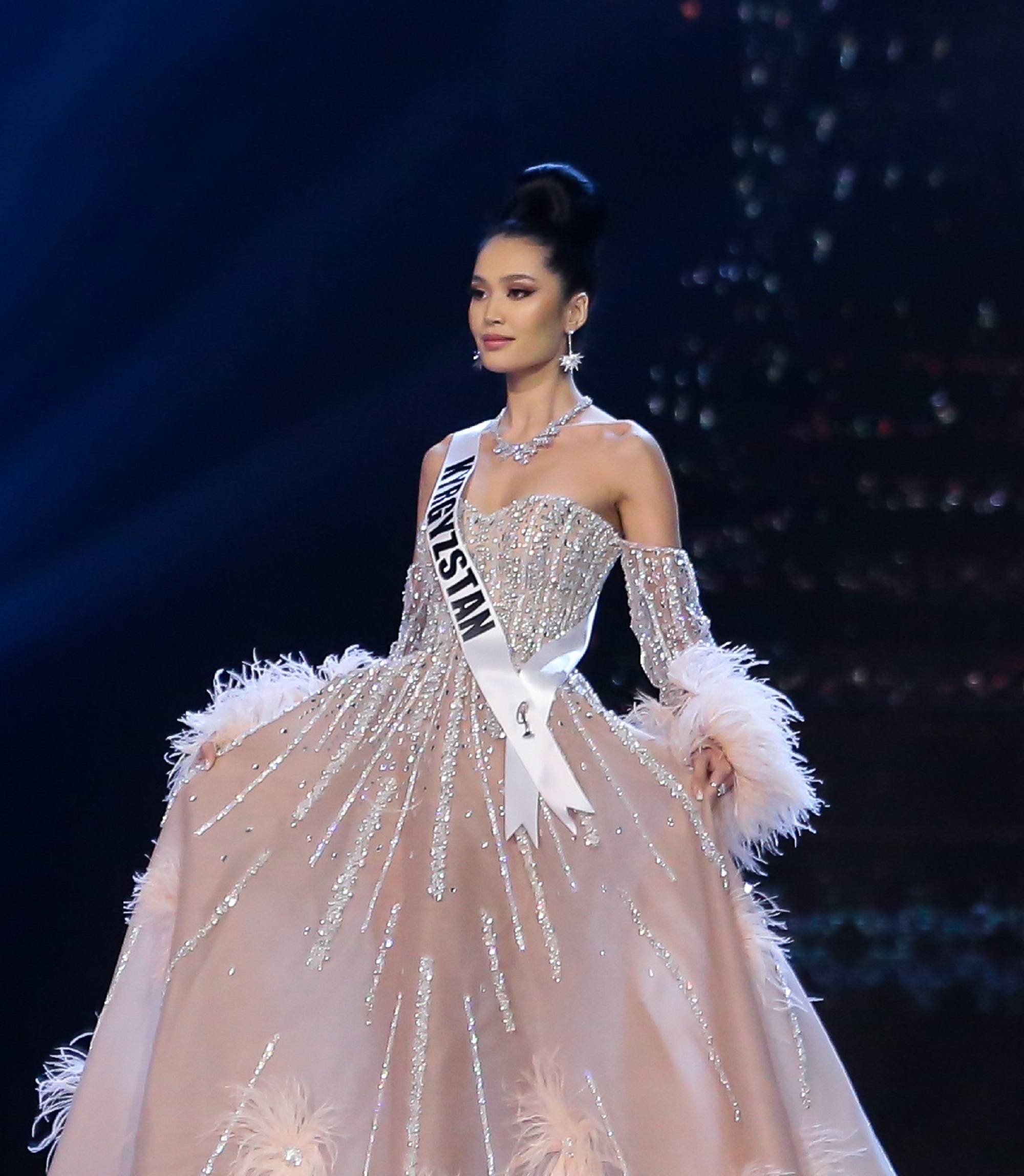 Miss Universe 2018 hairstyles : Ms. Kyrgyzstan Begimay Karybekova with black hair in a bun and light pink ball gown on stage