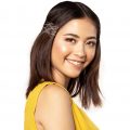 New Year's Eve Hairstyles: Asian woman with shoulder-length hair wearing a sleeveless top and smiling