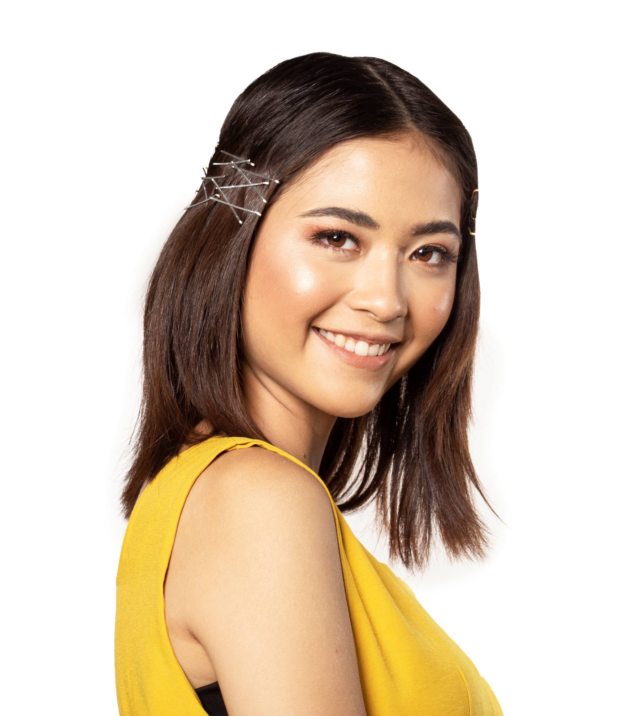 New Year's Eve Hairstyles: Asian woman with shoulder-length hair wearing a sleeveless top and smiling