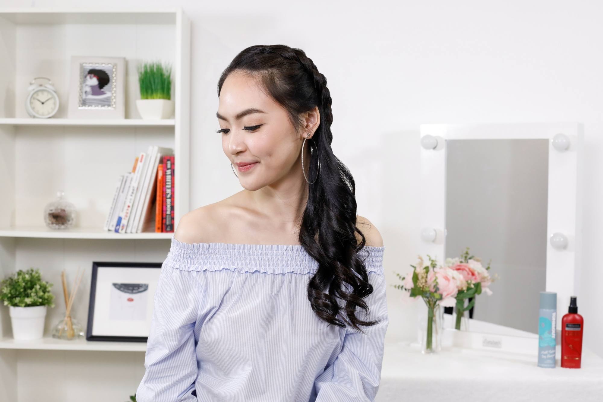 New Year's Eve Hairstyles: Asian woman with long hair wearing an offs-shoulder top