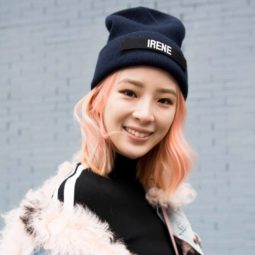 Peach hair: Asian woman with peach shoulder length hair wearing a black bonnet and black shirt