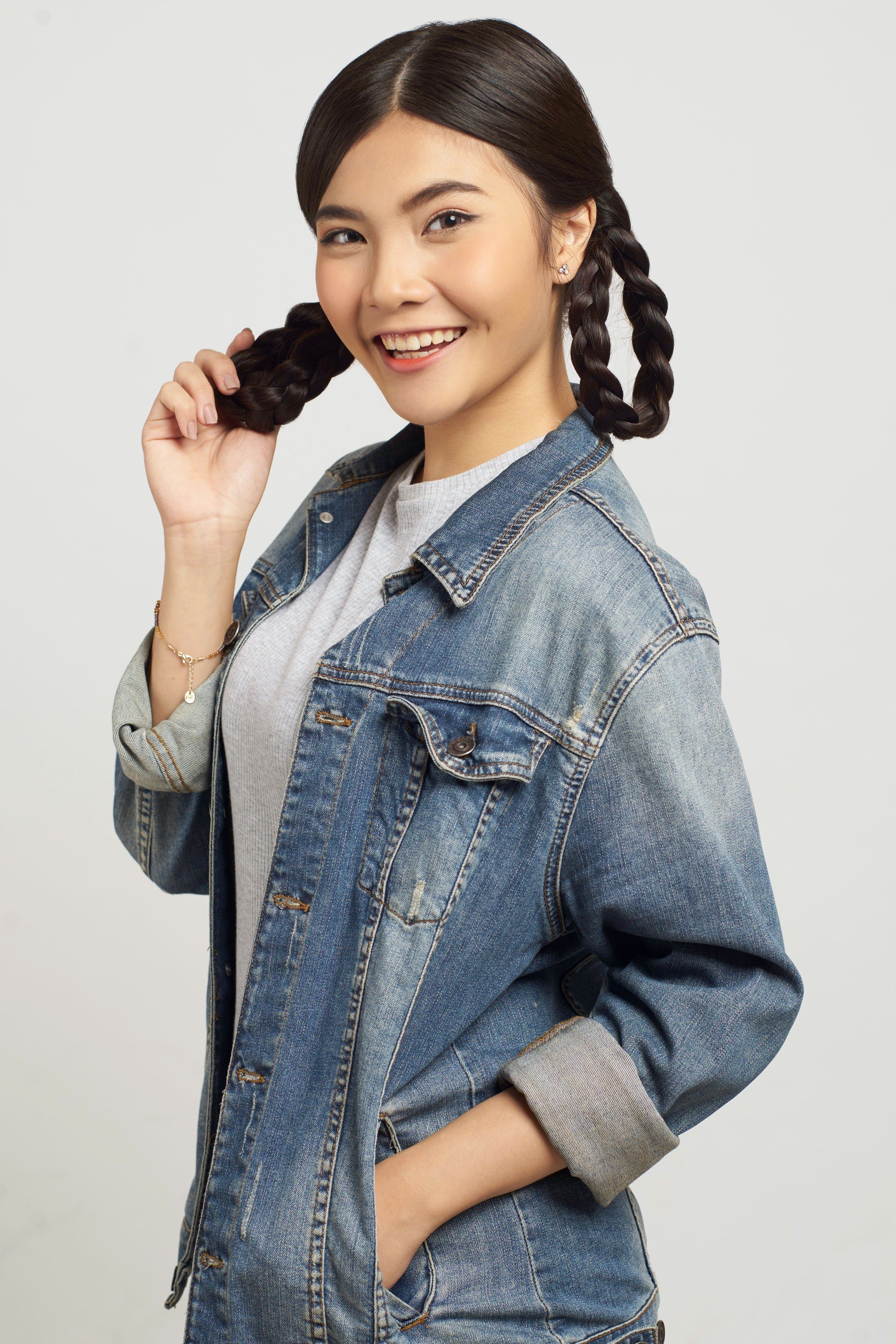 Asian girl is holding one of her looped braids