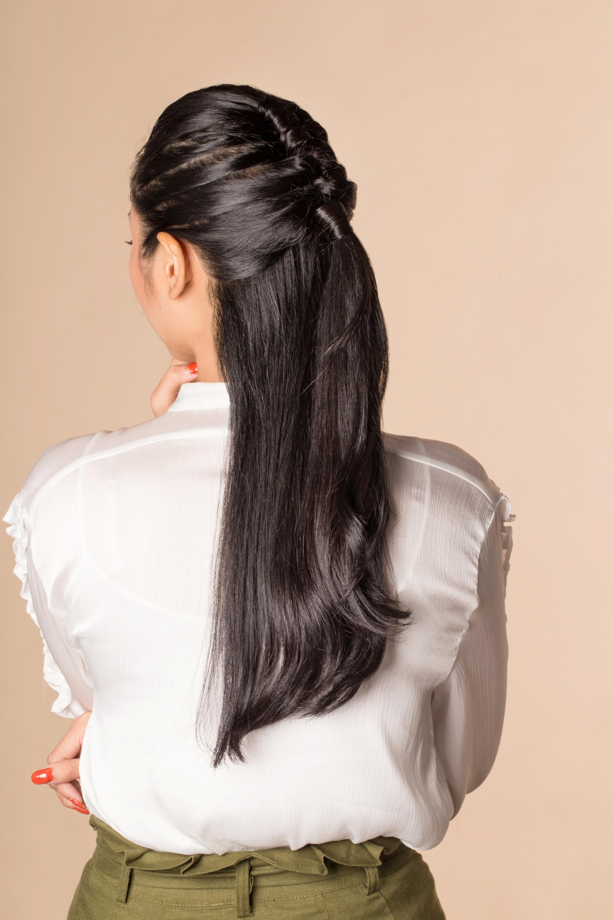 Back shot of an Asian woman with long hair in a half updo